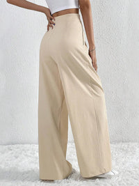 Beige wide-leg pants worn by a person on a white background