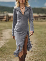 Woman wearing a gray fringe dress with a blurred outdoor background