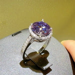 Ring with a purple gemstone on a gray surface