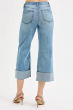 Light blue jeans worn by a person on a white background
