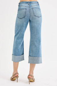 Light blue jeans worn by a person on a white background