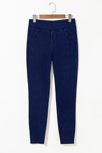 Blue pants with white trim on a hanger against a white background