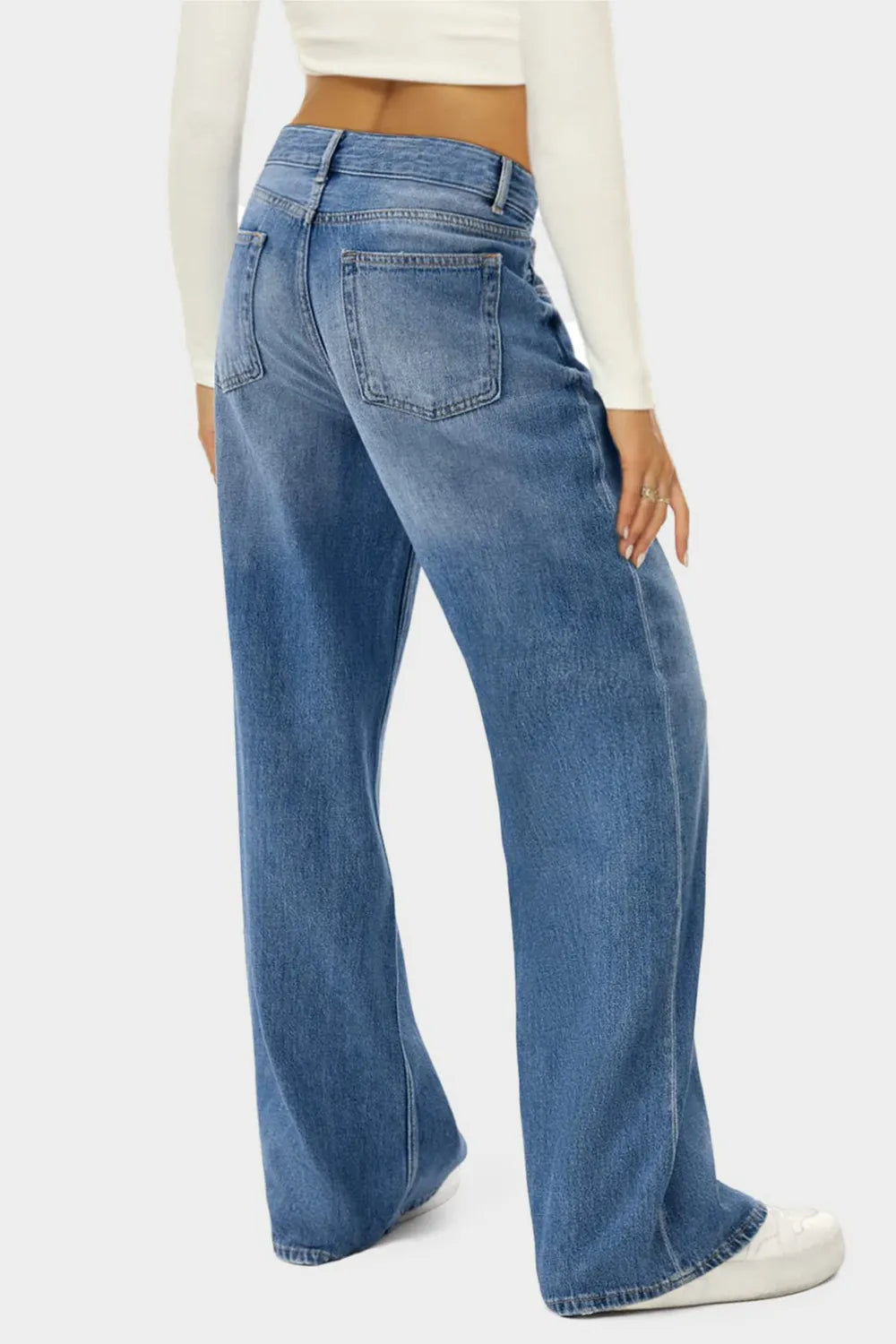 Person wearing blue jeans on a white background