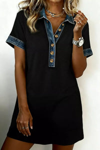 Black dress with denim collar and buttons on a plain background