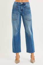 Blue jeans worn by a person on a white background