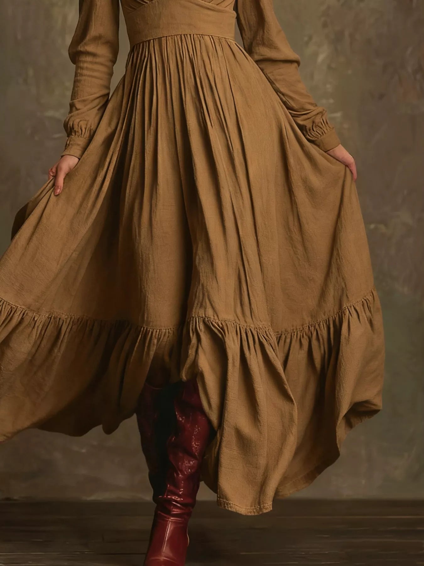 Person wearing a long brown dress with a textured background