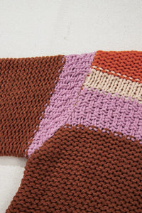 Close-up of a knitted fabric with brown, pink, and beige pattern on a white background