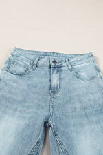 Light blue denim jeans on a light gray background