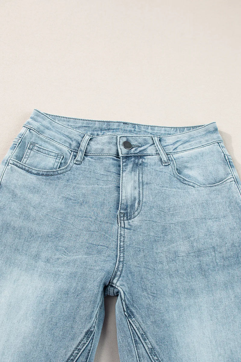 Light blue denim jeans on a light gray background