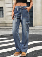 Person wearing blue cargo jeans on a city street.