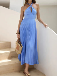 Woman in a blue dress standing on a staircase