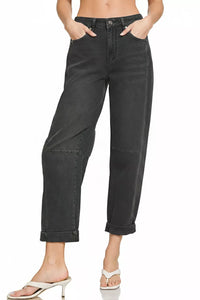 Black jeans worn by a person on a white background