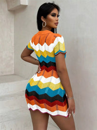 Woman wearing a colorful striped dress against a neutral background