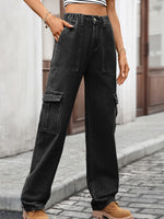 Person wearing black cargo pants on a street.