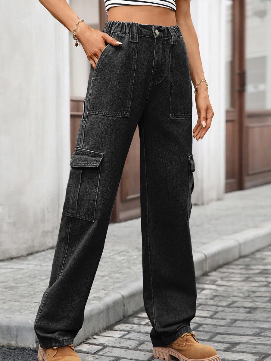 Person wearing black cargo pants on a street.