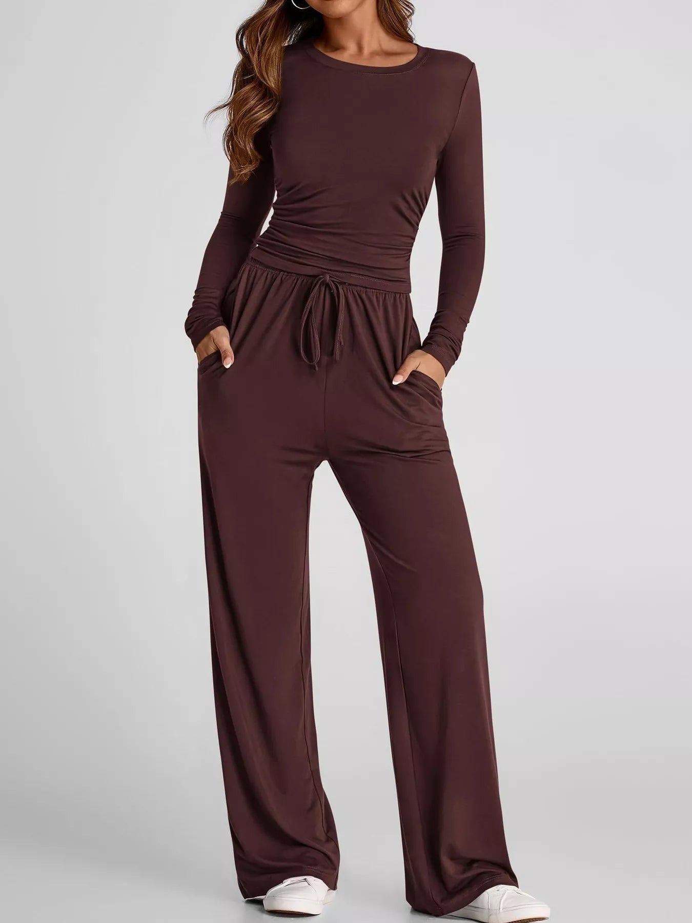 Brown long-sleeve top and wide-leg pants set on a plain background