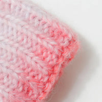 Close-up of a pink and white textured fabric on a light background