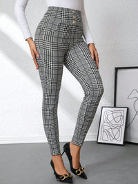 Person wearing plaid pants with a white background
