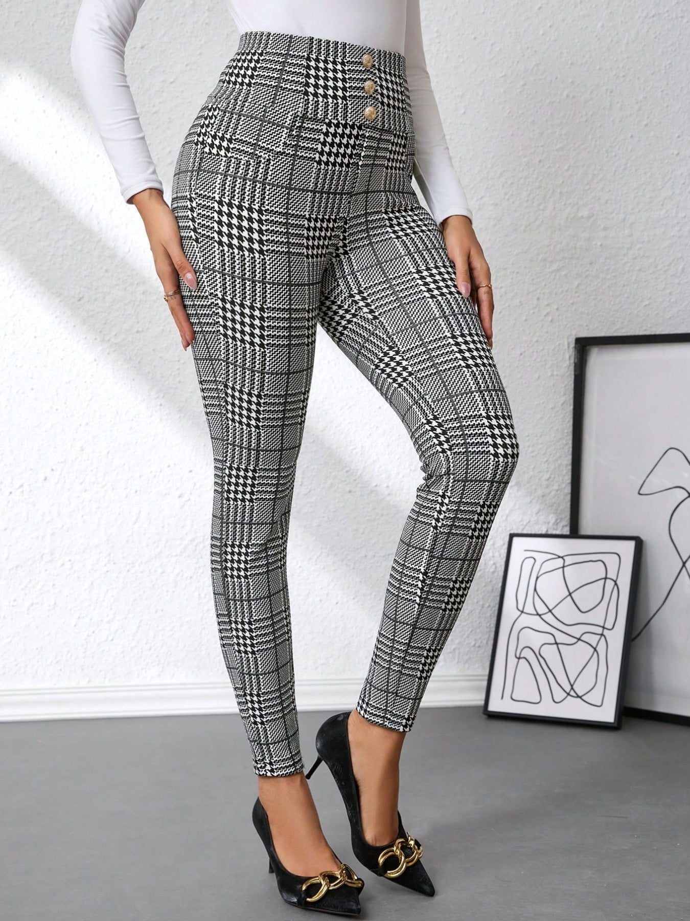 Person wearing plaid pants with a white background