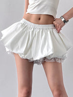 White skirt with lace hem on a plain background
