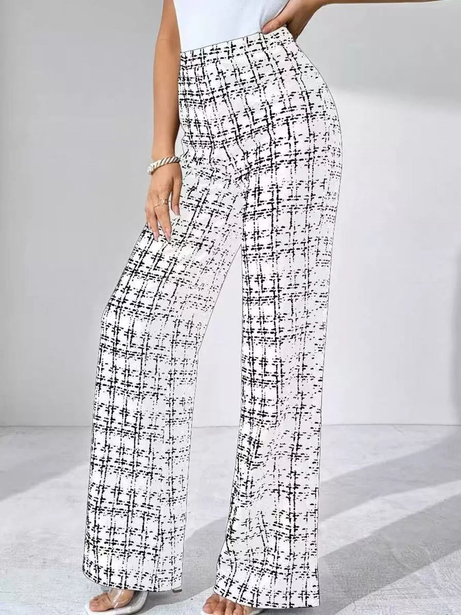 Black and white checkered pants worn by a person on a light gray background
