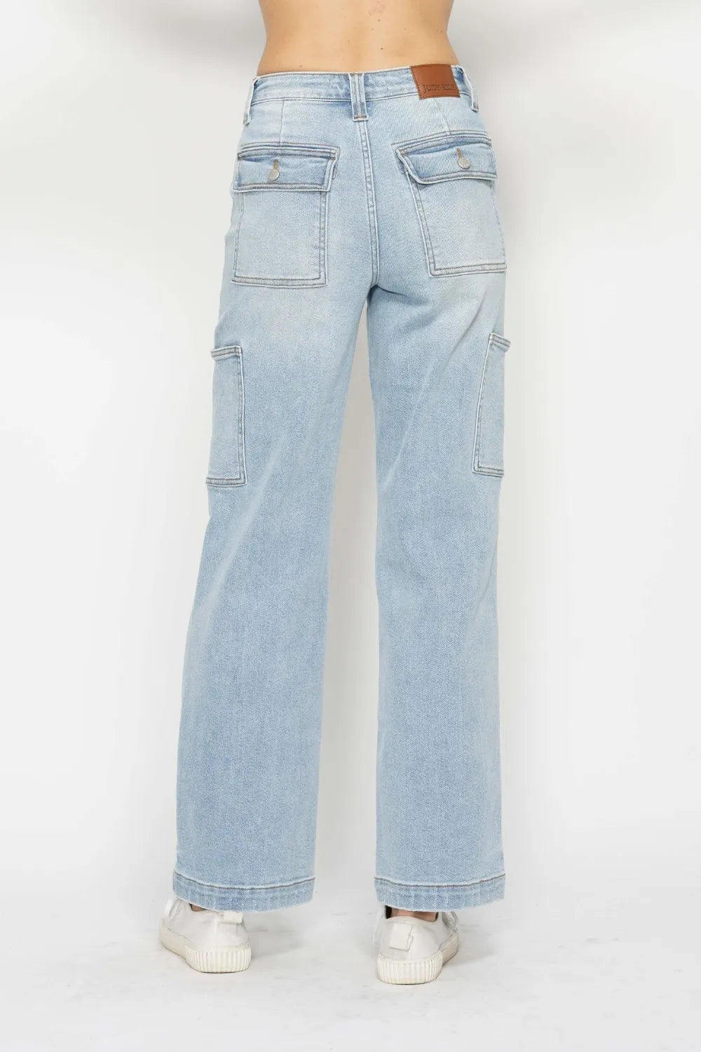 Light blue jeans worn by a person on a white background