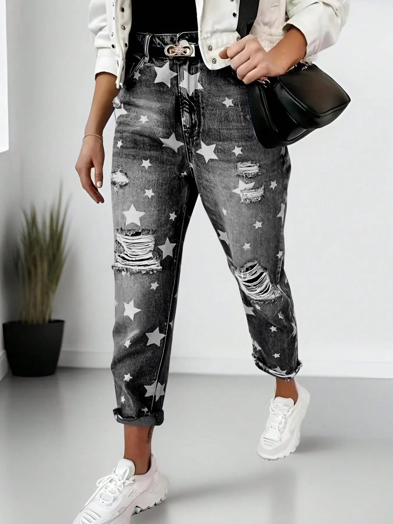 Person wearing star-patterned jeans with a white background
