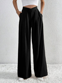 Black wide-leg pants worn by a person on a white background