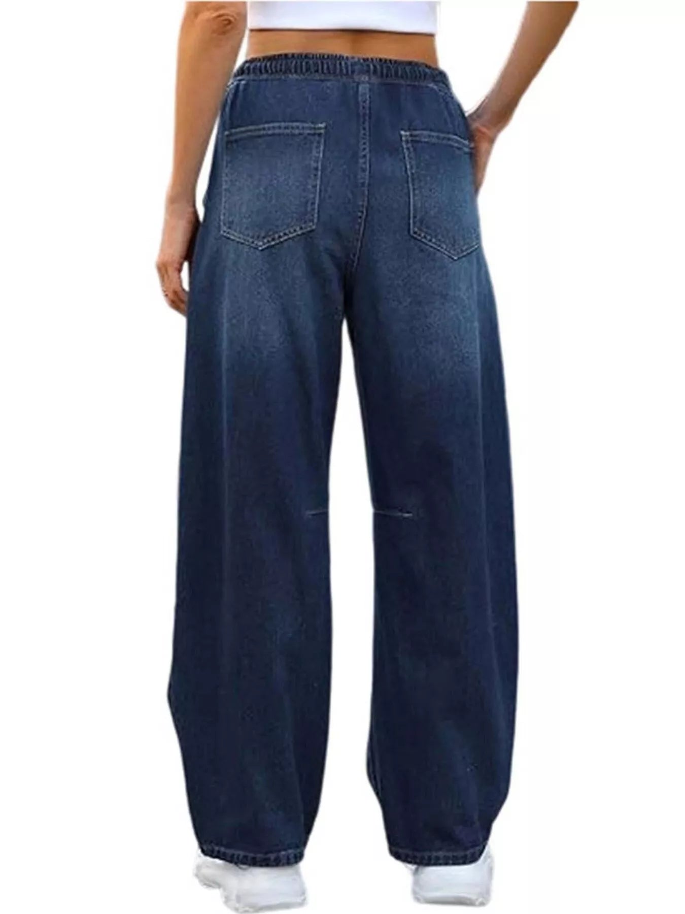 Person wearing blue wide-leg jeans on a white background