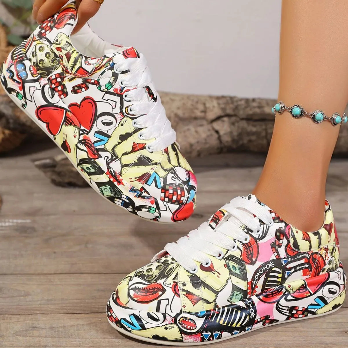 Colorful graffiti-style sneakers worn by a person on a wooden floor.