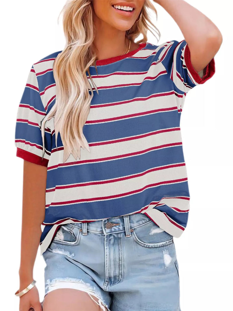Woman wearing a blue, red, and white striped shirt with denim shorts on a white background