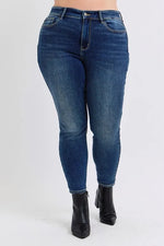 Blue jeans worn by a person on a white background