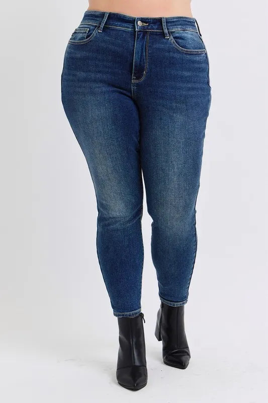 Blue jeans worn by a person on a white background