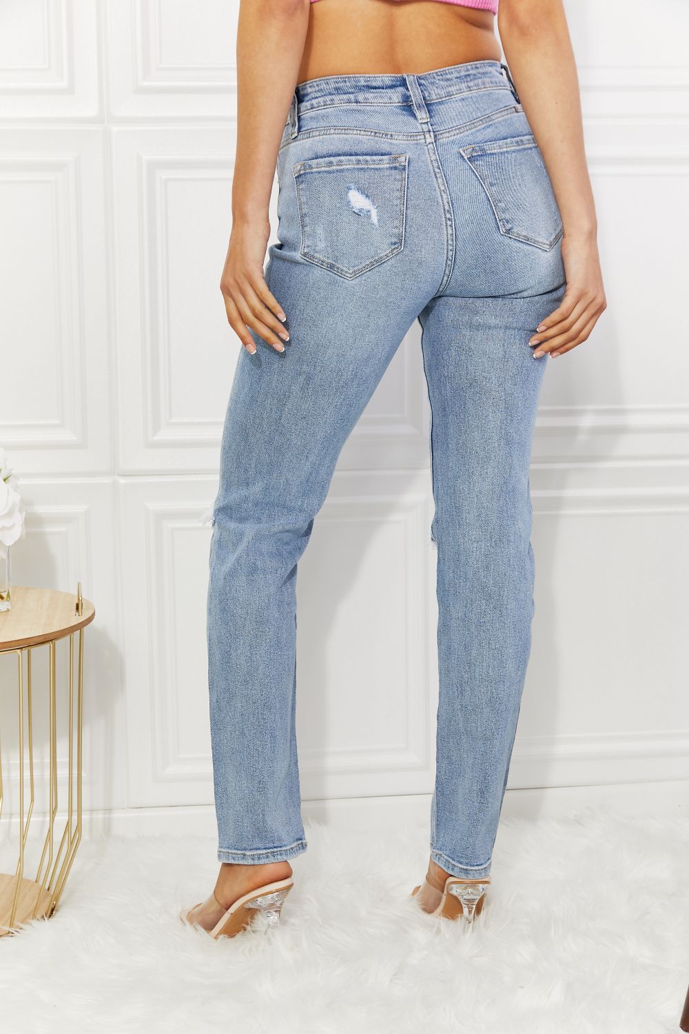 Light blue jeans worn by a person on a white background
