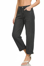 Person wearing black jeans on a white background