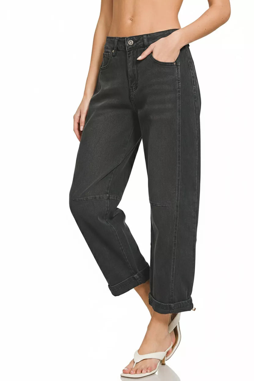 Person wearing black jeans on a white background