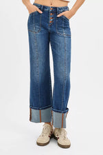 Person wearing blue jeans with a white background