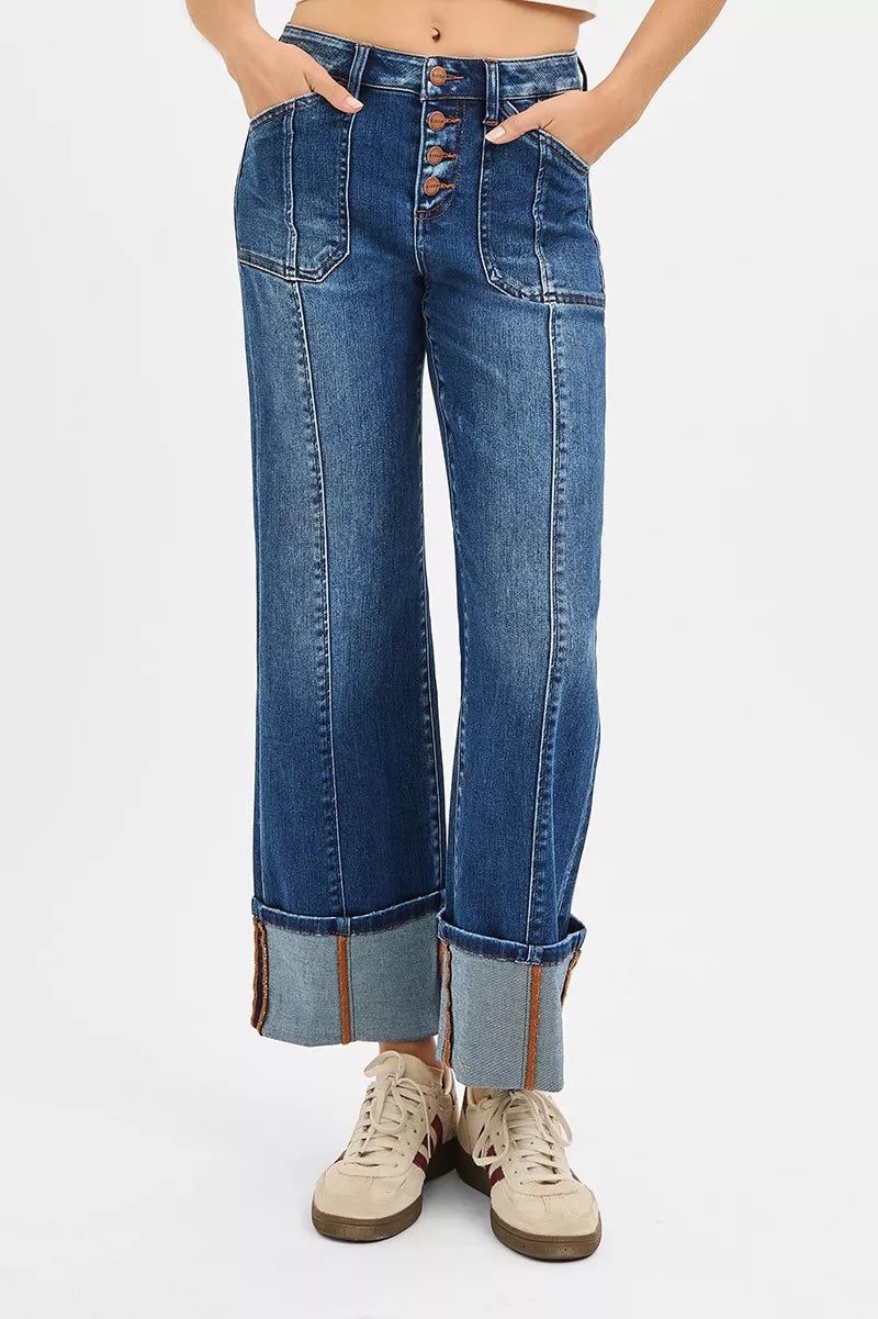 Person wearing blue jeans with a white background