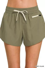 Olive green shorts with a drawstring on a white background