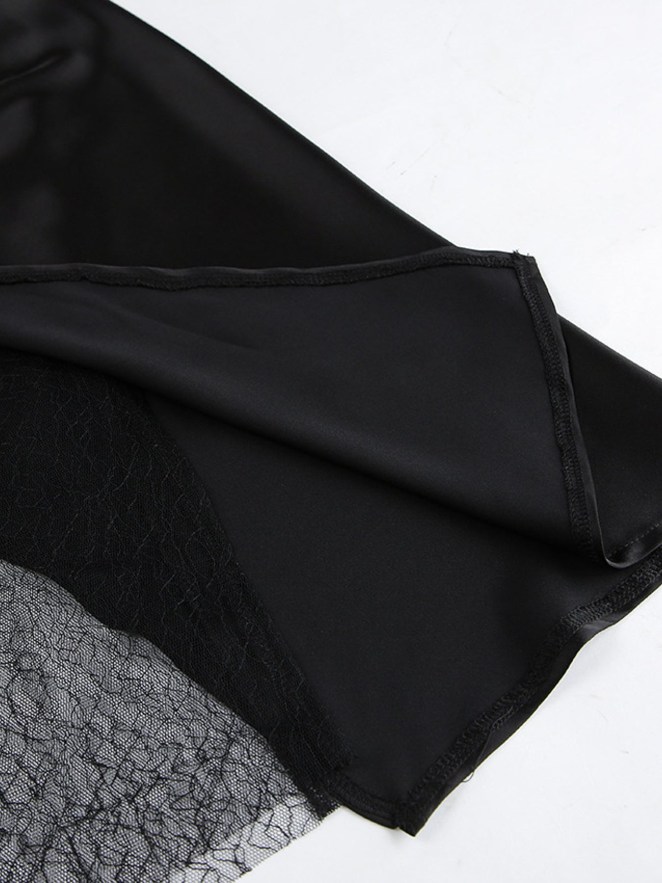 Black fabric with lace trim on a white background