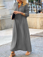 Woman wearing a long gray dress in an urban setting