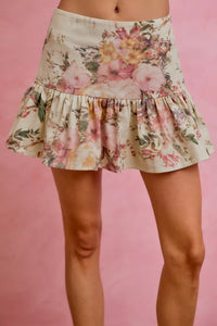 Floral skirt worn by a person on a pink background