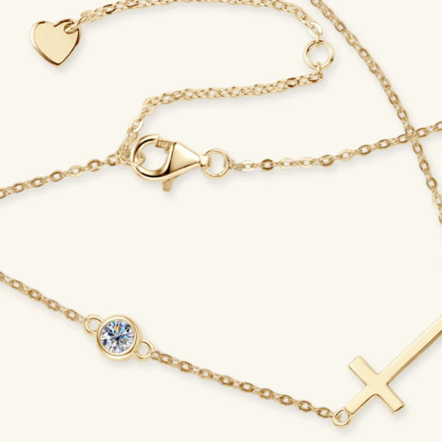 Gold bracelets with various charms on a white background