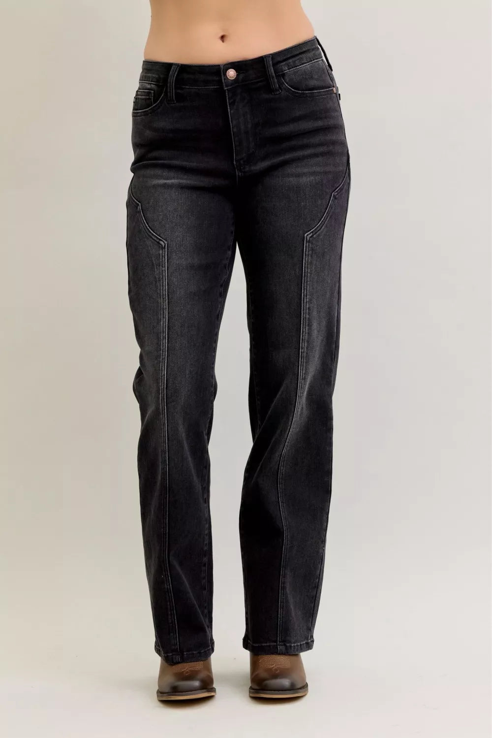 Black jeans worn by a person on a plain background