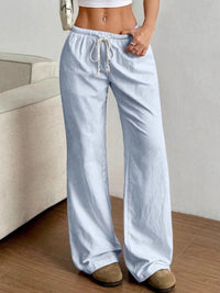 Light blue striped pants worn by a person in a casual setting.