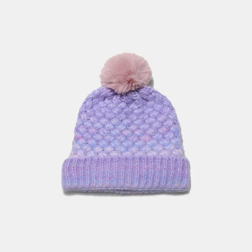 Purple knit beanie with a pink pom-pom on a light gray background