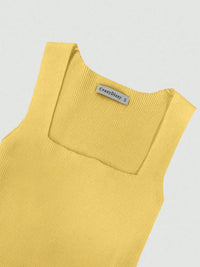 Yellow sleeveless top with a brand label on a light gray background