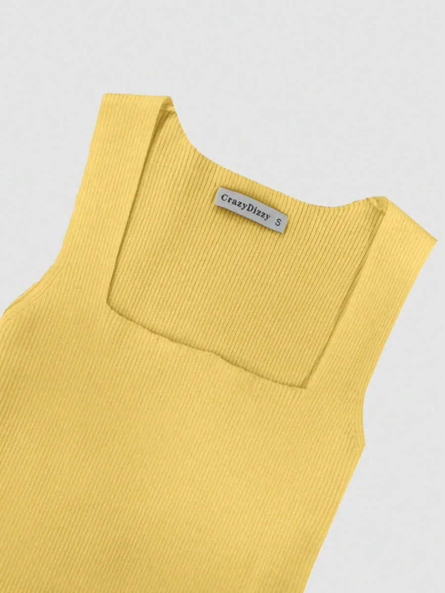 Yellow sleeveless top with a brand label on a light gray background