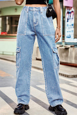 Person wearing light blue cargo jeans on a city street.