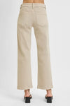 Beige pants worn by a person on a white background